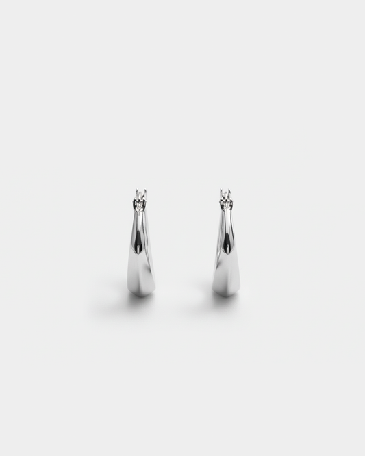 ahrensandco Paradoxe Earring – asymmetrische skulpturale Creolen aus Edelstahl mit polierter Oberfläche, minimalistisches Design aus Paris
