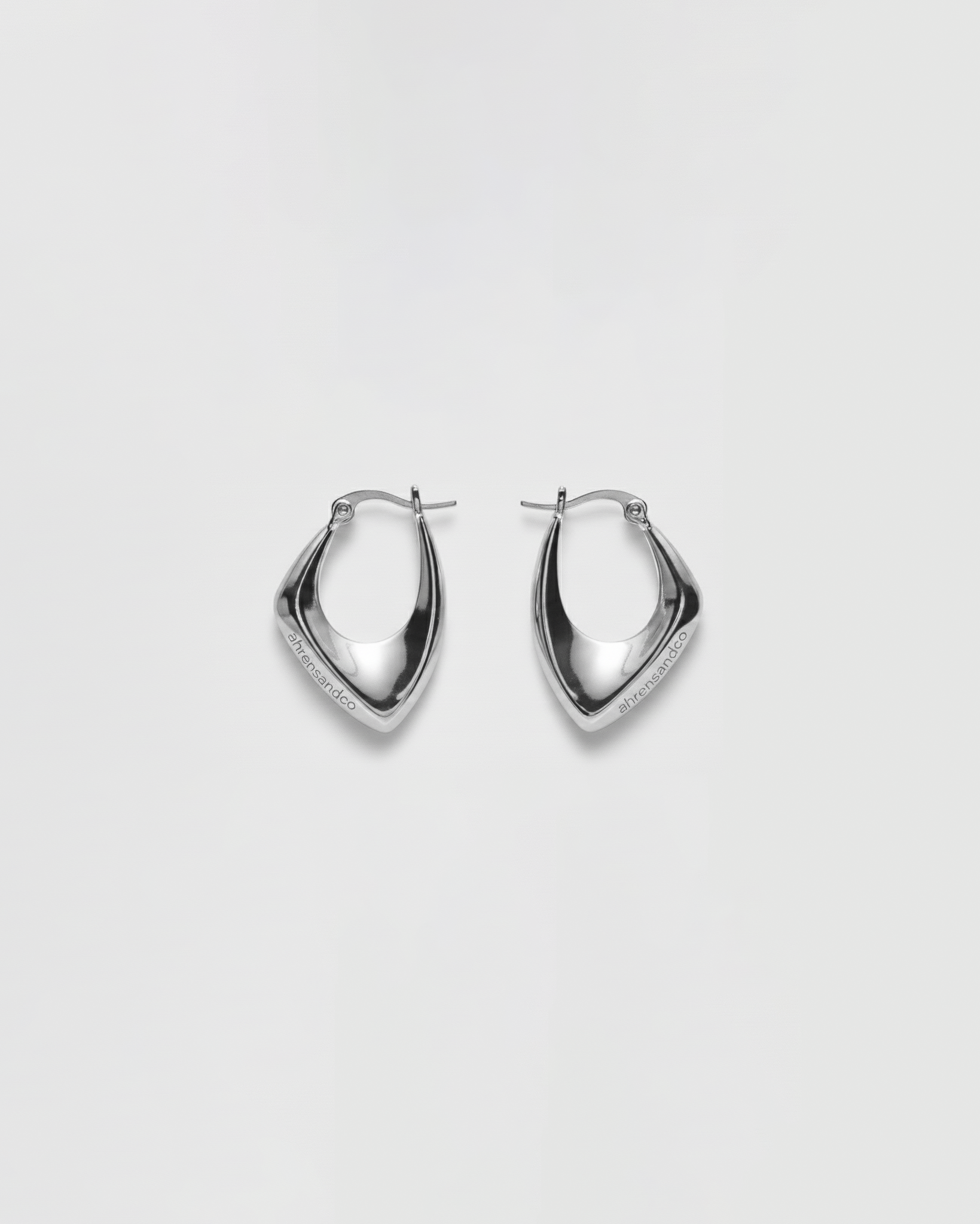 ahrensandco Paradoxe Earring – asymmetrische skulpturale Creolen aus Edelstahl mit polierter Oberfläche, minimalistisches Design aus Paris
